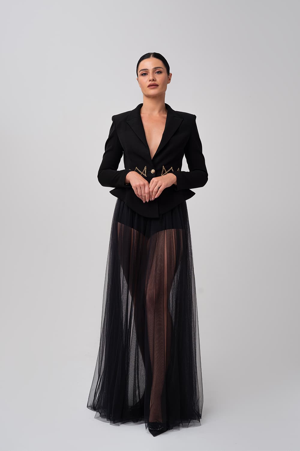 Tailored black jacket over a tulle maxi skirt, front view